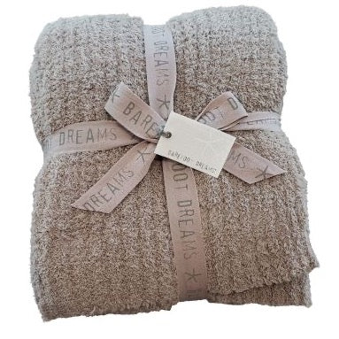 folded gray blanket tied with a bow and branded tag
